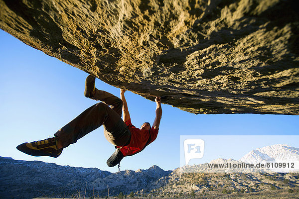 Man bouldering on an overhang
