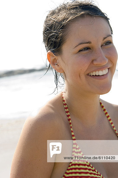 Portrait of woman on beach in bikini.