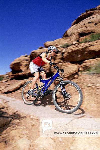 Woman mountain biking in Moab  Utah