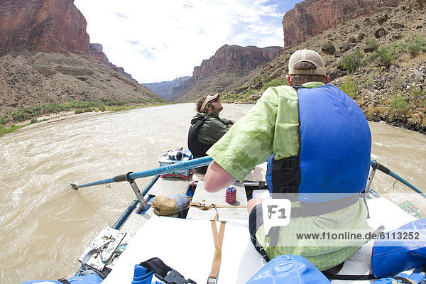 Two men in a raft in the Grand Canyon.