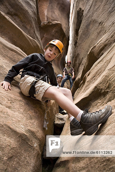 Young boy exploring a slot canyon.