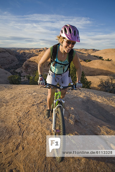 woman mountain biking  Moab  Utah