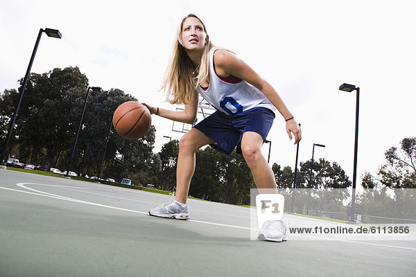 Action shot of a woman playing basketball.