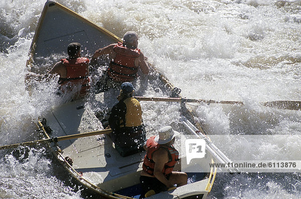A wooden dory is tossed in the whitewater of 24-Mile Rapid on the Colorado River in Grand Canyon National Park  Arizona.