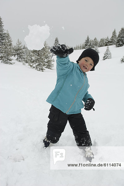boy throwing snowball  San Juan National Forest  Colorado.