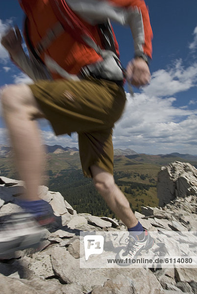 Young man hiking on rocky peak  San Juan National Forest  Colorado (blurred motion).