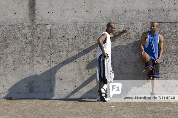 Two men chat after basketball game in Portland  Oregon.