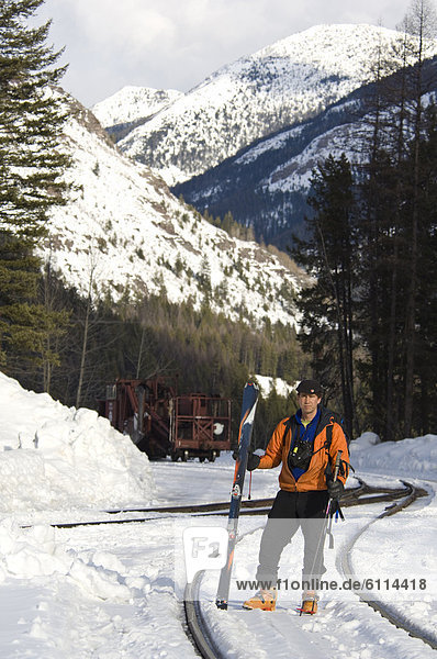 Avalanche forecaster with train in Rocky Mountains  Montana.