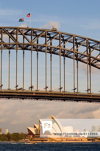 Sydney Harbour Bridge and Opera House  with Australian and Aboriginal flags flying from the top of the span