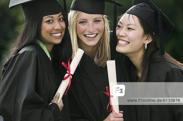 Young women graduating in cap and gown