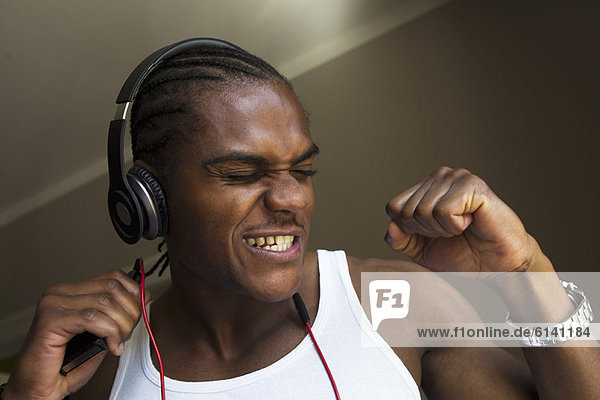 Smiling man singing with headphones