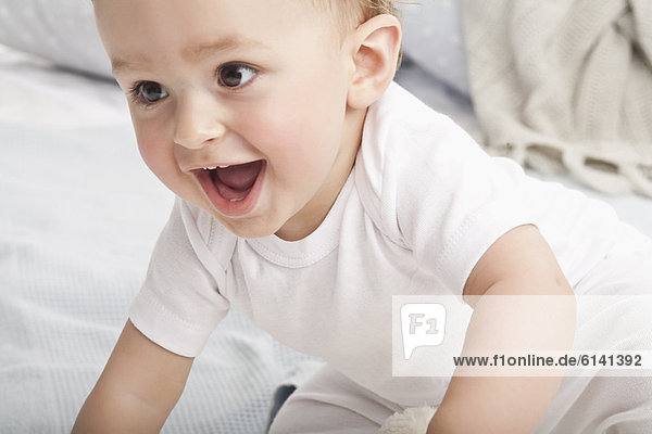 Laughing baby crawling on couch
