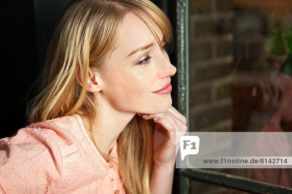 Woman looking through window  close up