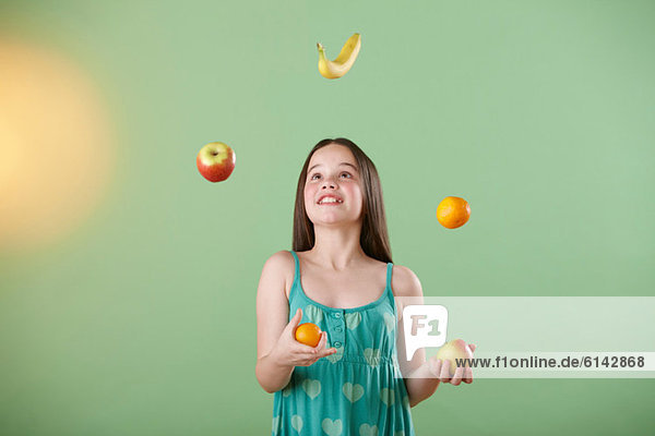 Girl juggling fruit