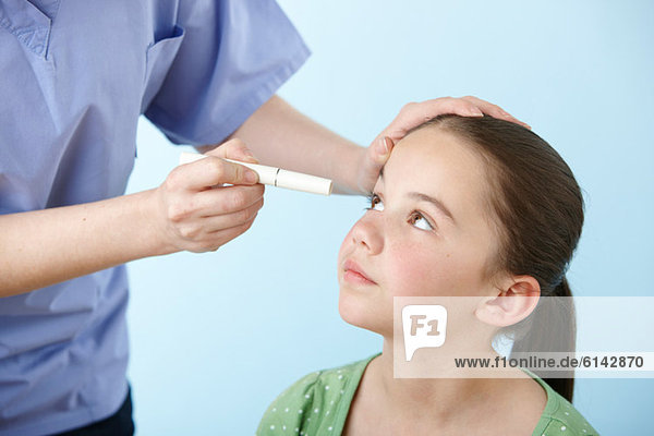 Girl having eye test