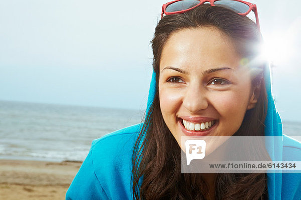 Young woman in hooded top on beach