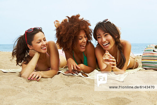 Young women sunbathing on beach