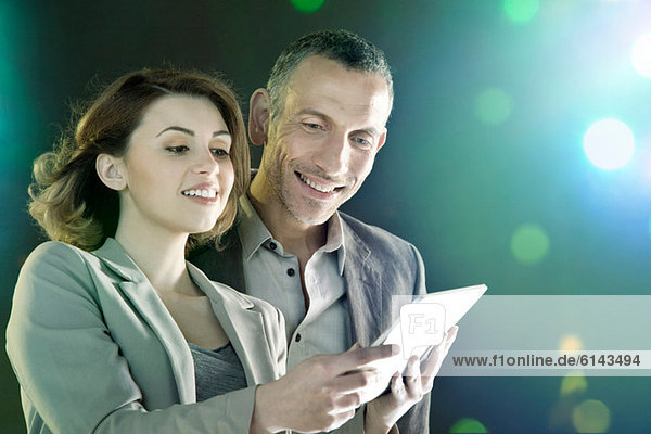 Businesspeople looking at digital tablet