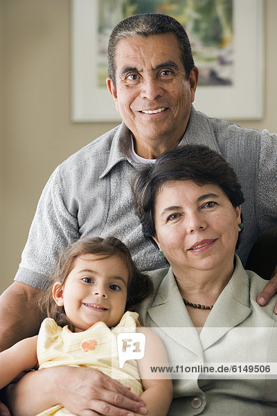 Portrait of grandparents with granddaughter