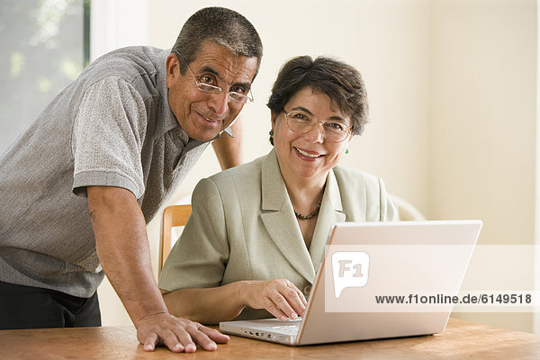 Portrait of mature couple with laptop