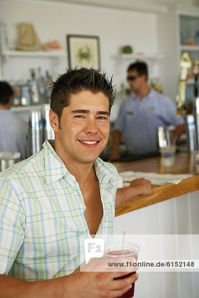 Young man drinking at bar