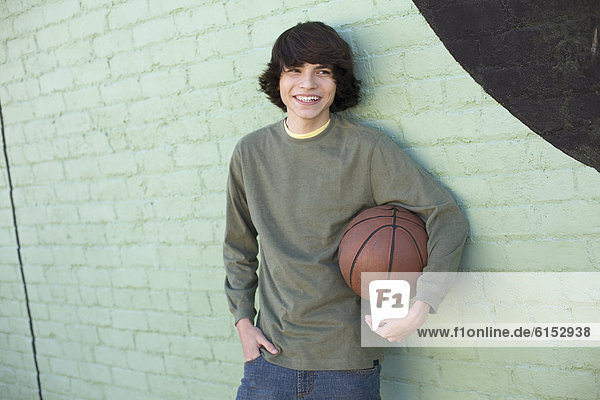 Hispanic boy holding basketball