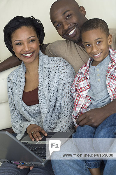 Portrait of African family with laptop
