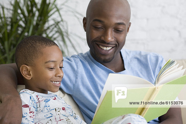 African father and son reading