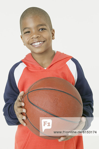 African boy holding basketball