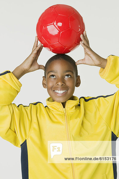 African boy holding soccer ball