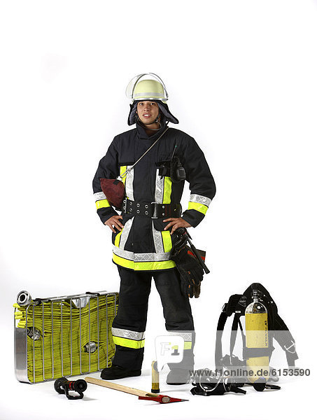 Fireman  part of a response squad for firefighting  with protective clothing made of Nomex  a helmet with a visor  a fire axe  respiratory protective equipment  a flashlight  a two-way radio  a fire hose nozzle  fire hose in a carry basket  C-hose  safety rope  a professional firefighter from the Berufsfeuerwehr Essen  Essen  North Rhine-Westphalia  Germany  Europe