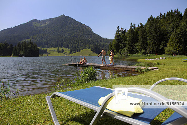 Sun lounger on lake Spitzingsee  a mountain lake  1084 meters above sea level  Mangfall mountains  Upper Bavaria  Bavaria  Germany  Europe