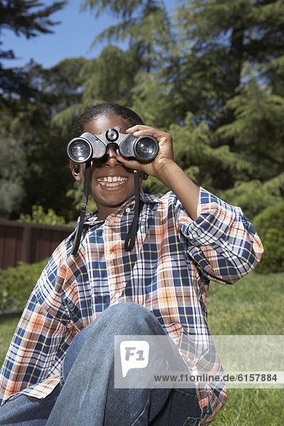 African boy looking through binoculars