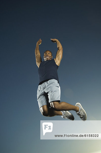 African American man jumping