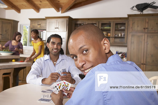 Multi-ethnic friends playing cards