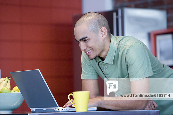 African American man looking at laptop