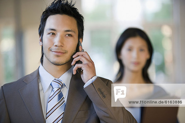 Asian businessman talking on cell phone