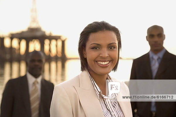 African American businesswoman in front of businessmen
