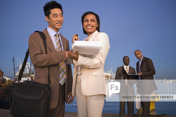 Multi-ethnic businesspeople on commercial pier