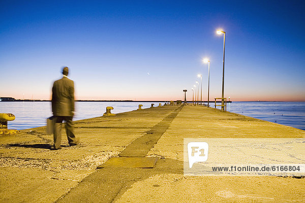 African American businessman walking on commercial pier