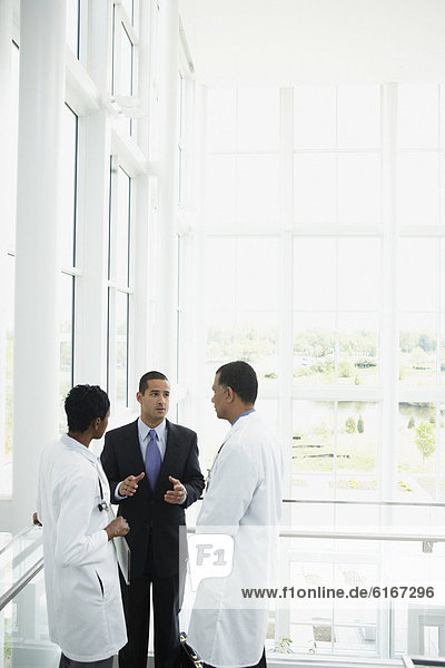 Doctors talking to businessman