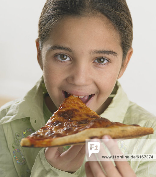 Young girl eating pizza
