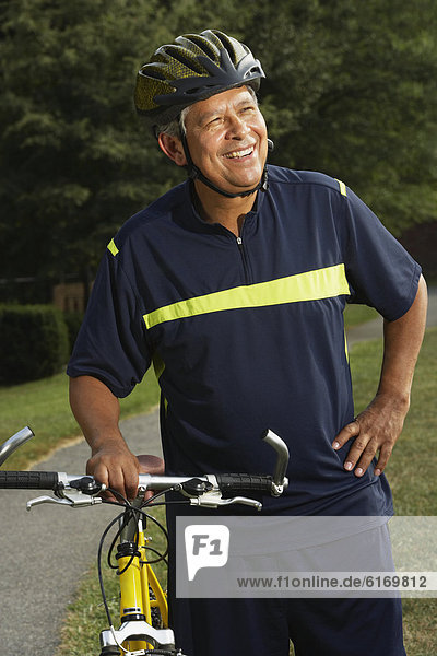 Hispanic man next to bicycle