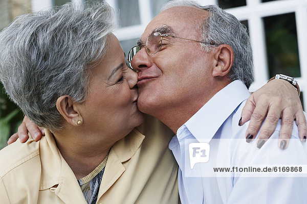 Senior Hispanic couple kissing