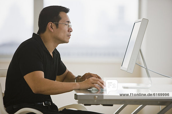 Asian businessman looking at computer
