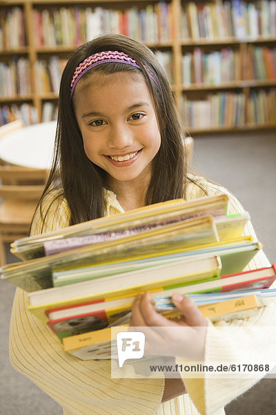 Pacific Islander girl holding library books