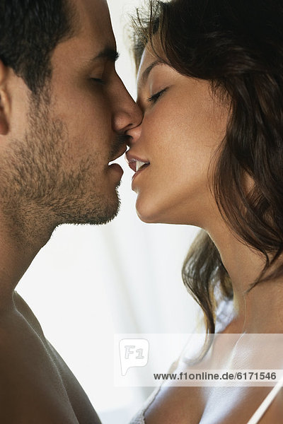 Hispanic couple kissing