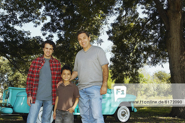Multi-ethnic family in front of truck