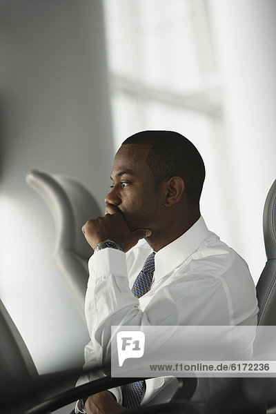African American businessman sitting in chair