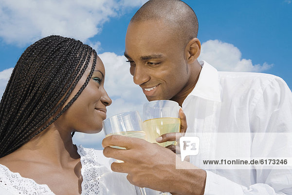 African couple drinking wine